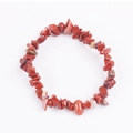 Handmade bracelet featuring natural irregular red jasper stone beads on a white background - Red Jasper