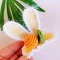 Handmade crochet bunny ear hair clip featuring white yarn and orange carrot detail - Orange Tangerine Rabbit Ears