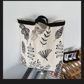 Minimalist cream canvas tote bag with black plant leaf prints and durable black handles - Off-white Leaves