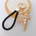 Golden coconut tree keychain with rhinestones, pearls and black braided leather strap - Coconut Tree + Heart Lanyard