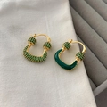 Χρυσά σκουλαρίκια σε σχήμα U με πράσινο ζιργκόν και σμάλτο σε λευκό υφασμάτινο φόντο - Πράσινο