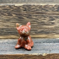 3cm red jasper hand-carved French Bulldog gemstone figurine on a wooden background - Red Sesame
