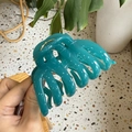 Close-up of a large teal pumpkin claw clip with wave texture and gold metal hinge detail - Teal