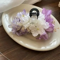 Elegant purple and white floral hair clip on a ceramic tray for spring styling - Purple Flower Shark Claw Clip