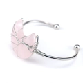 Macro detail of silver wire-wrapped moon-shaped pink crystal on a polished bangle - Rose Quartz