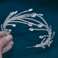 Close-up of silver bridal headband with flowing rhinestones and teardrop crystals - DZ113 / Silver