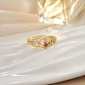 Detail of a golden crown ring with red heart gemstone and micro-pave crystals - Red Heart Crown Style (JZ0135A)