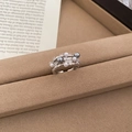 Detailed top view of a three-layer zircon pearl ring on a soft tan velvet jewelry tray - Three-Layer Pearl Zircon Design / Silver