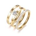 Detailed view of three gold titanium rings featuring screw motif and sparkling zircon - US 5 / Gold