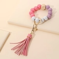 Detail of pink and purple wooden beads keychain with gold clasp and leather tassel - Pink Tassel
