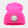 Neonroze gebreide muts met smiley-patch en gouden lovertjes details voor de winter - Rozerood