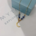 Detail of 18k gold plated moon pendant and blue marble bead on a light blue jewelry box - Moon Pendant Blue Beads (N123月亮-蓝色)