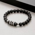 Macro detail of 8mm black lava stone beads and silver skull charm on a beaded bracelet - Black Lava Stone Style (KB183249-TLX)