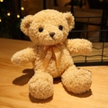 Close-up of small teddy bear plush shell with curly fur and an orange silk bow tie - Light Brown Bow Tie Style / 30cm