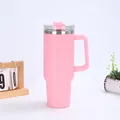 Pink 40oz insulated tumbler with handle and straw on a desk with a wooden calendar - Pink (Generation 1)