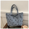 Light blue corduroy tote bag featuring black bow accents and diamond quilted patterns - Blue