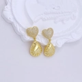 Detail of gold heart earrings with water drop pendants on a white vintage tray - Heart Teardrop Texture Earrings