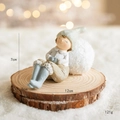 Winter resin angel girl figurine with blue hat sitting on wood base with a snowball - Blue Boy