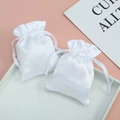 Glossy white satin drawstring pouch for jewelry packaging on a decorative tray - 7x9cm / White