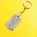 Letter V stainless steel keychain with matte finish and detachable split ring on yellow background - Letter V