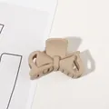 Detail of a matte beige bow-shaped hair claw clip with minimalist hollow line design - 4.5CM / 4.5cm Bowknot-Light Coffee