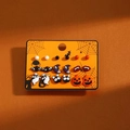 Close-up of Halloween earring set featuring enamel ghost, pumpkin, and bat designs - DE81705