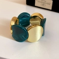 Macro detail of acrylic marble resin and gold metal modular stretch bracelet - Gold-Green