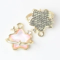 Macro detail of colorful star pendants with gold plating and sparkling rhinestones - Gold Base Pink
