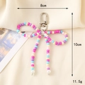 Handmade beaded bow charm with pink and purple beads and a silver lobster clasp - Rose Red Seed Bead Bow Keychain