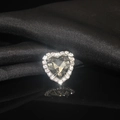 Macro shot of heart-shaped crystal with rhinestone border on black silk reflection - Dark Grey