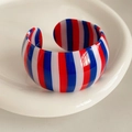 Detail of wide open cuff bracelet featuring red, white, and blue vertical stripes finish - Blue Red White Vertical Striped Style