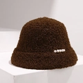 Detail of brown faux fur bucket hat with white pearl accents on white pedestal - Brown