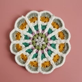Handmade crochet round coaster featuring gradient yarn patterns on a pink background - No. 10 Gradient