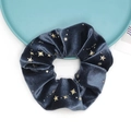 Close-up of navy velvet scrunchie featuring gold foil star patterns and soft texture - Blue Grey
