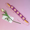 Handmade crochet floral headband with purple and pink daisies on a soft pink background - Rose Pink Daisy