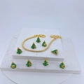 Detailed view of a gold snake chain bracelet with green enamel Christmas tree charms - Dark Green/Gold