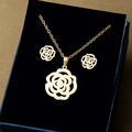 Detailed view of golden hollow rose pendant necklace and earrings set in jewelry box - Hollow Camellia Rose Style