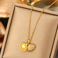 Macro shot of a golden shell pendant necklace with a white pearl and zircon accents - Shell Pearl Opening Pendant