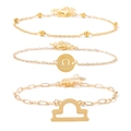 Three-piece golden Libra zodiac bracelet set for women on a clean white background - Libra