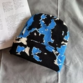 Macro detail of blue and black knitted beanie showing soft pixelated texture on fabric - One Size / Black & Blue Cow Print