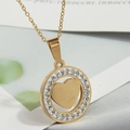 Detailed view of a gold-plated necklace featuring a zircon-encrusted circle and heart pendant - Gold Heart