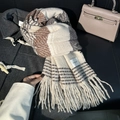 Thick beige and brown plaid winter scarf with fringe paired with a dark toggle coat - Beige