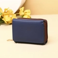 Detail of navy blue tri-fold wallet with brown lining and gold ring zipper head - Dark Blue