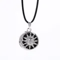 Solar and lunar black onyx necklace featuring celestial face relief on woven cord - Sun & Moon Motif