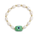Detail of freshwater pearl bracelet with golden beads and a green evil eye rectangular charm - Green