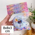 Blue donut squishy toy with colorful sprinkles in original PINCH FAMILY packaging - Blue Donut with Bite