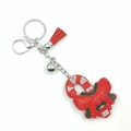 Detail view of a sparkling rhinestone Santa candy cane keychain with a red tassel and bell - Christmas Candy Cane