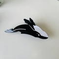 Detail of whale-shaped hair claw clip with black and white acetate finish in a macro view - Black Whale