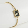 Adjustable gold stainless steel bracelet featuring a black enamel letter K pendant - K-Black