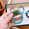 Dettaglio dell'elastico per capelli peluche turchese con un ciondolo a cuore verde - Cuore Verde Scuro